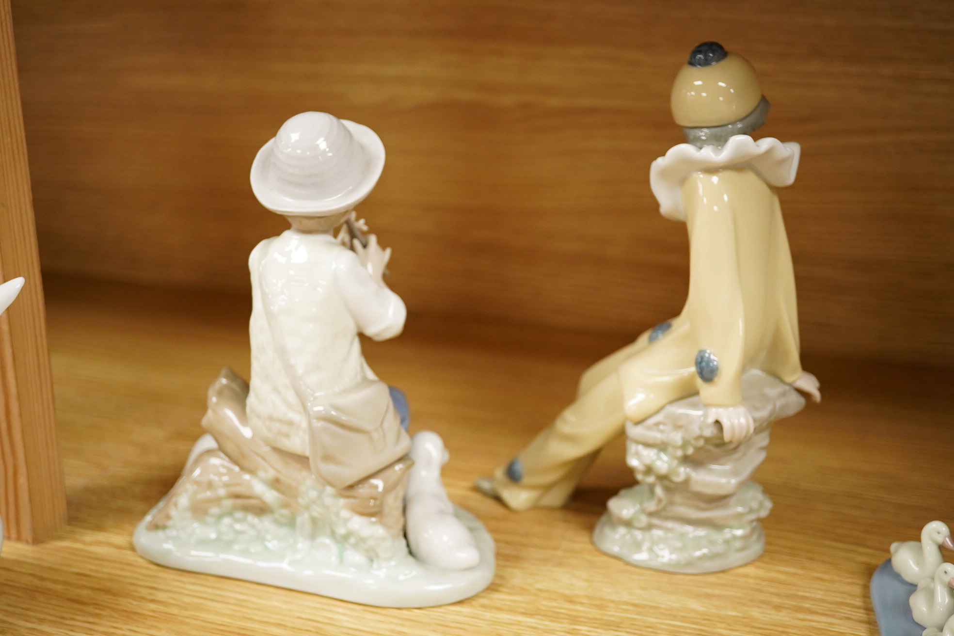 Four Lladro and Nao figures and a Doulton Toby jug, The Lawyer, largest 20cm high